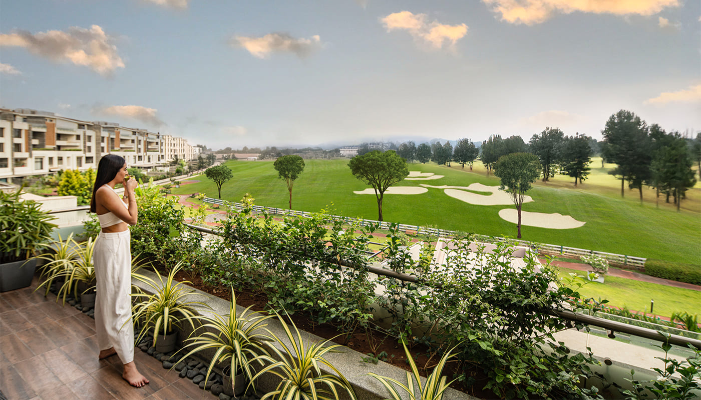 Aerial view of Embassy Grove luxury villaments in Indiranagar, Bangalore, overlooking the prestigious Karnataka Golf Course with private pools, landscaped pathways, and panoramic city views